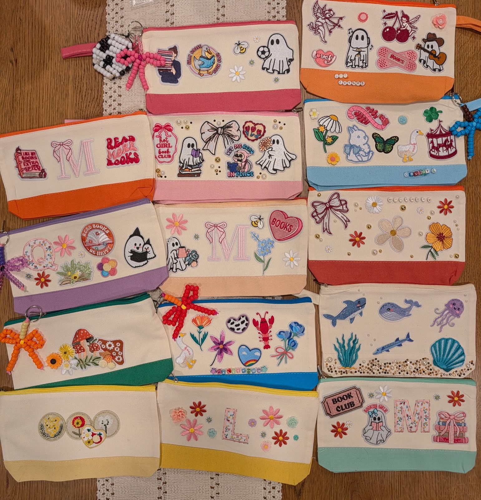 A colorful collection of hand-decorated book club craft pouches