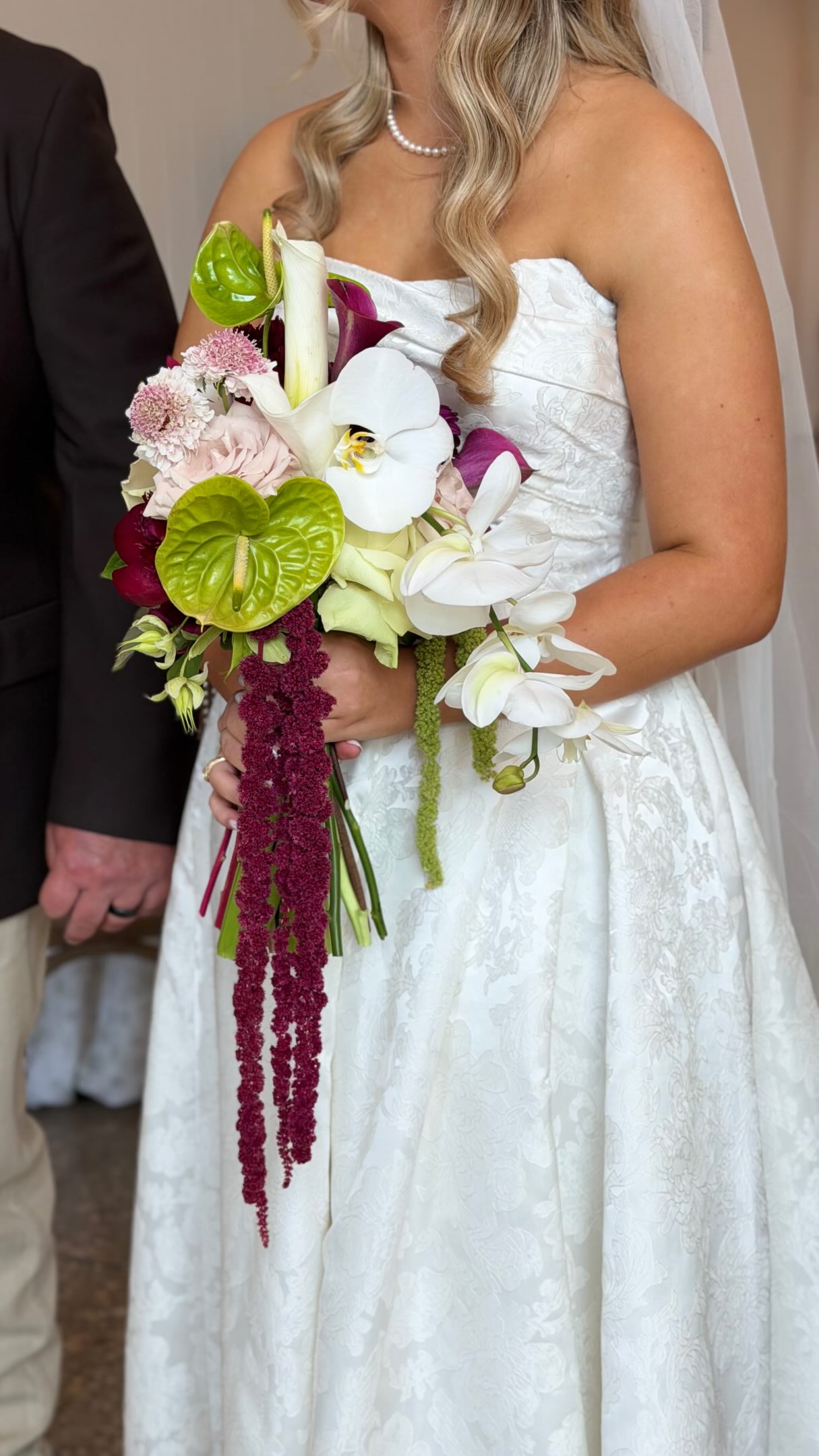 A sculptural Lily in June bridal bouquet with green and berry flowers